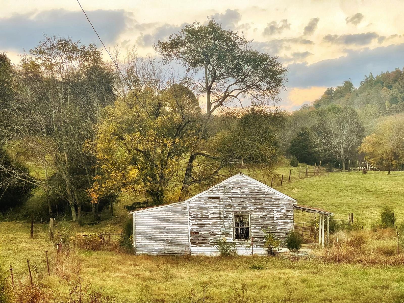 Small stone farm building set in a pasture